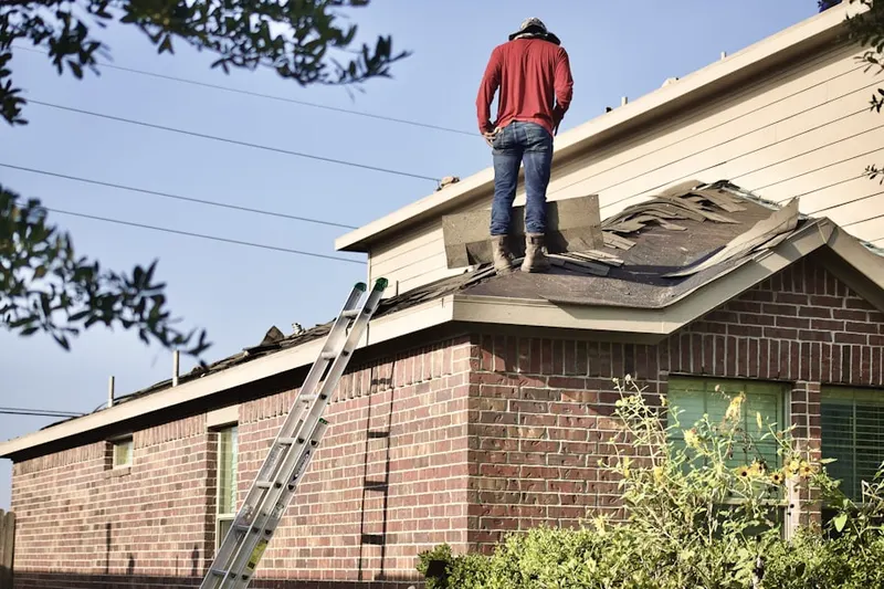 Professional roofer working on a residential roof in Western Springs